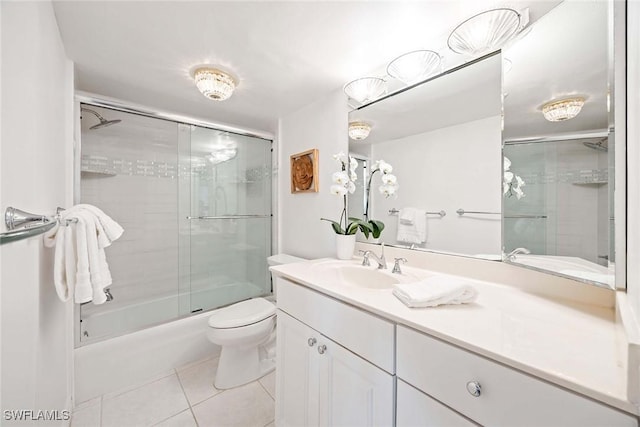 full bath with toilet, shower / bath combination with glass door, tile patterned flooring, and vanity