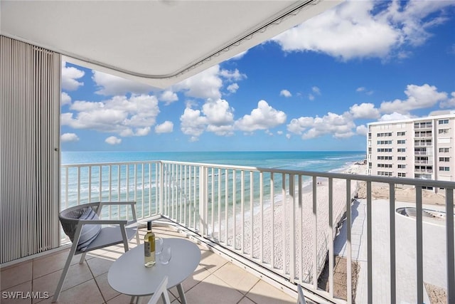 balcony with a beach view and a water view