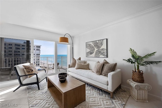 living area with light tile patterned floors, baseboards, a water view, and crown molding