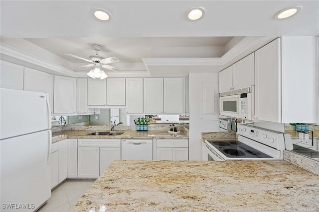 kitchen with ornamental molding, white appliances, a sink, and white cabinetry