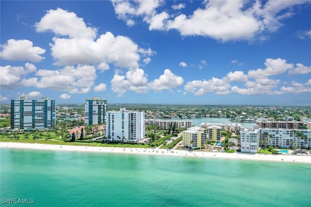 drone / aerial view with a view of city, a water view, and a view of the beach