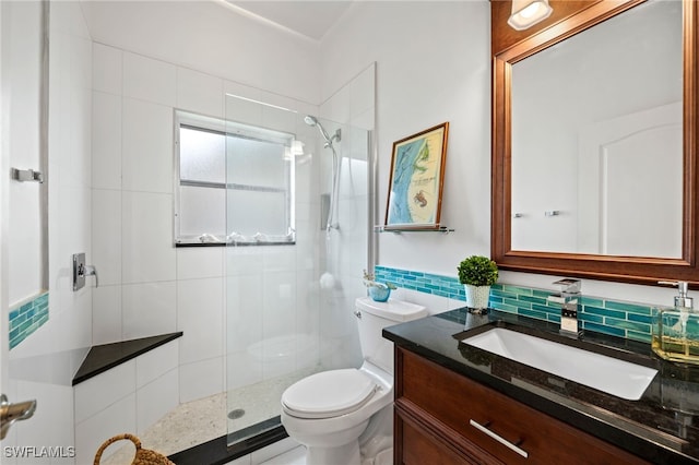full bathroom featuring a stall shower, vanity, toilet, and tile walls