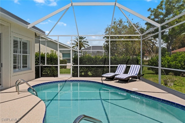 outdoor pool featuring a lanai and a patio area