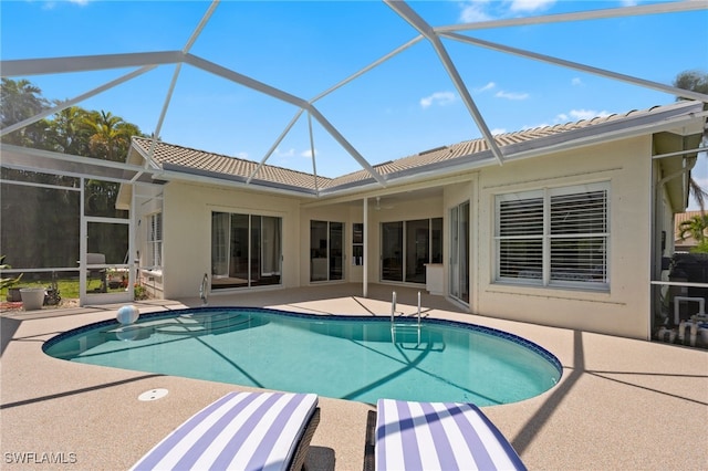 outdoor pool with a lanai and a patio area