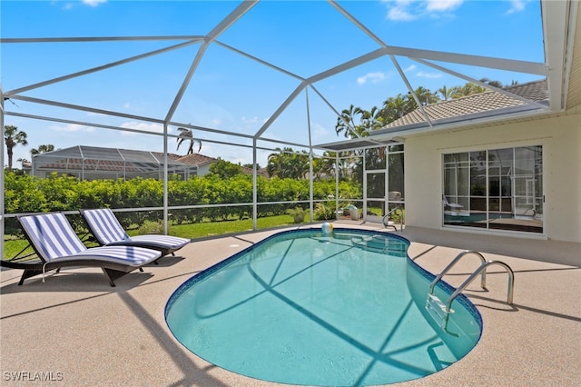 pool with a lanai and a patio area