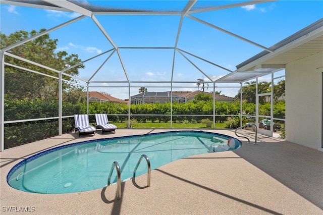 pool with glass enclosure and a patio area