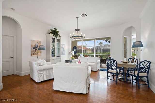 living room featuring baseboards, crown molding, visible vents, and dark wood-type flooring