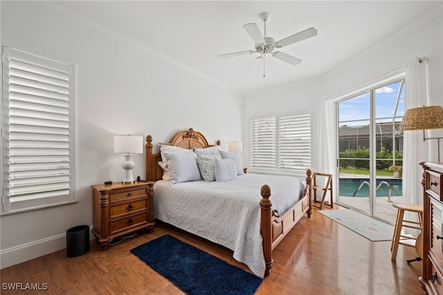 bedroom featuring baseboards, ceiling fan, wood finished floors, access to outside, and crown molding