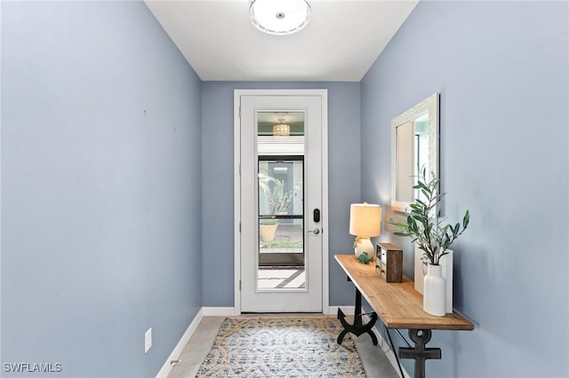 doorway to outside with baseboards