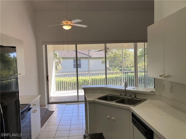 kitchen featuring light countertops, white cabinetry, a sink, dishwasher, and black / electric stove