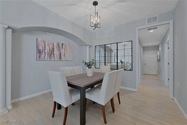 dining area featuring visible vents, light wood-style flooring, decorative columns, and baseboards