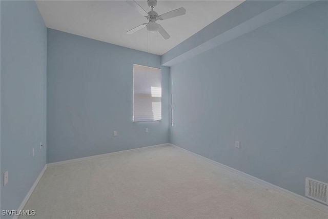 unfurnished room with ceiling fan, carpet floors, visible vents, and baseboards