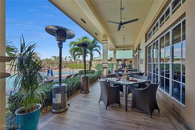 view of patio / terrace featuring ceiling fan, outdoor dining space, visible vents, and an outdoor pool