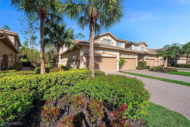 view of front of property with decorative driveway and stucco siding