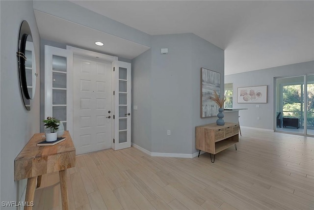 foyer with light wood finished floors, baseboards, and recessed lighting