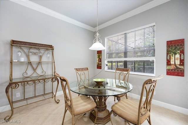 dining area with baseboards, crown molding, and light tile patterned flooring