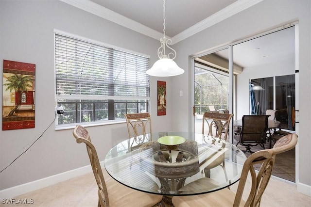 dining space with ornamental molding, light tile patterned flooring, and baseboards