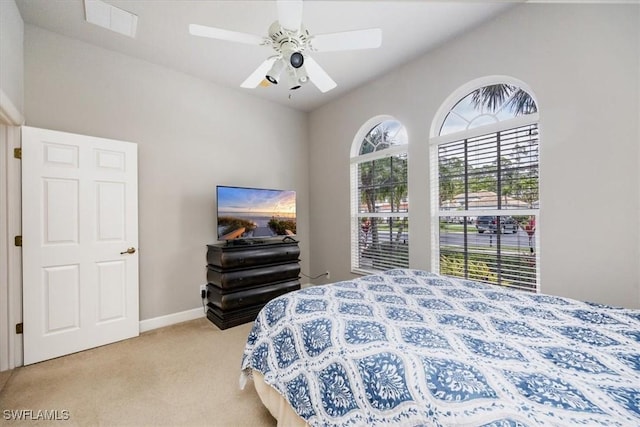 bedroom featuring light carpet, ceiling fan, visible vents, and baseboards