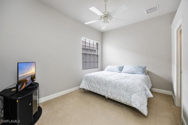 bedroom featuring light carpet, ceiling fan, visible vents, and baseboards