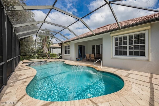 view of pool with a patio area, a lanai, and a pool with connected hot tub