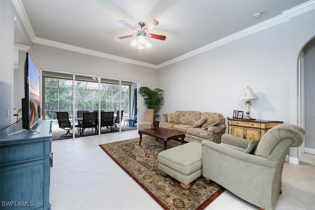 living room with ornamental molding, arched walkways, ceiling fan, and light tile patterned floors