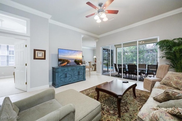 living room with ceiling fan, ornamental molding, a wealth of natural light, and baseboards