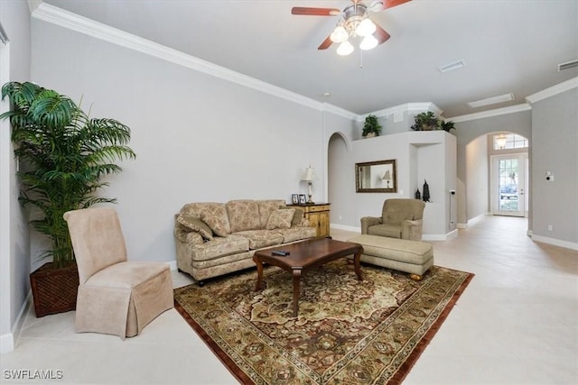 living area featuring arched walkways, baseboards, a ceiling fan, and crown molding