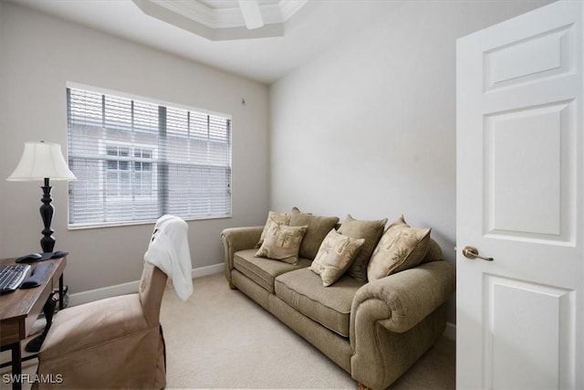 living room with ornamental molding, light carpet, ceiling fan, and baseboards