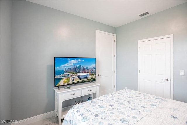 bedroom featuring visible vents and baseboards