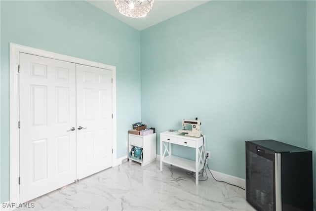 bedroom featuring marble finish floor and baseboards