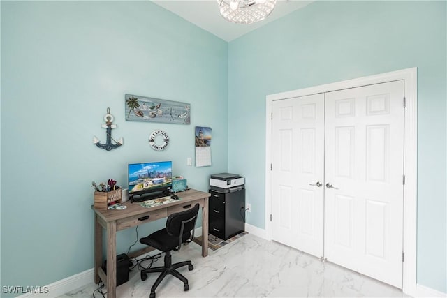 home office with marble finish floor and baseboards