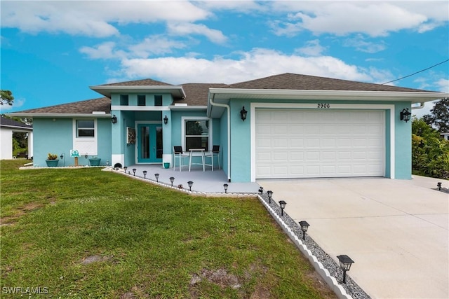 view of front facade featuring a garage, a front lawn, and stucco siding