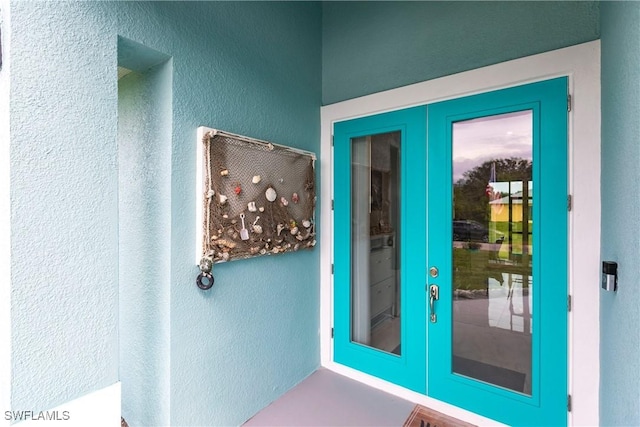 doorway featuring french doors and a textured wall