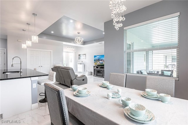 dining space featuring recessed lighting, marble finish floor, and an inviting chandelier