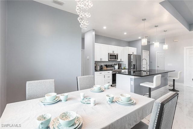 dining room with marble finish floor, recessed lighting, visible vents, and baseboards