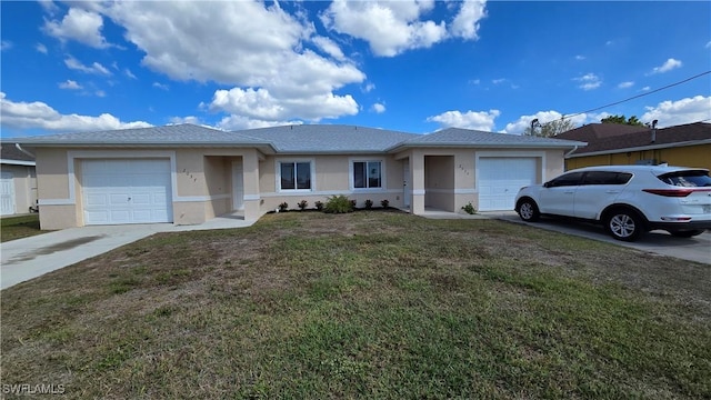 view of front of house with a garage, driveway, a front lawn, and stucco siding