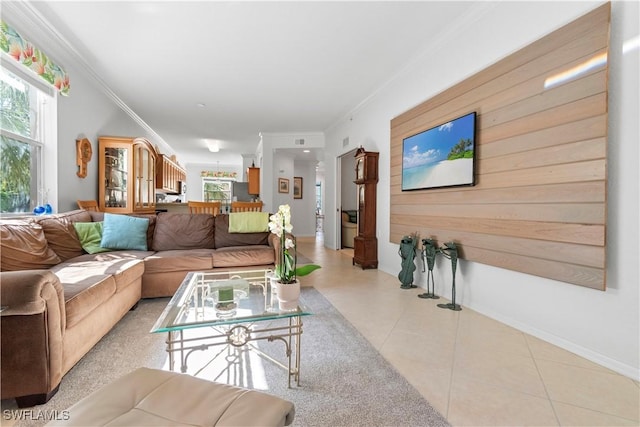 living area featuring light tile patterned floors and ornamental molding