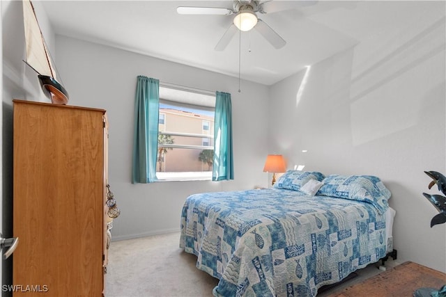 carpeted bedroom featuring a ceiling fan and baseboards