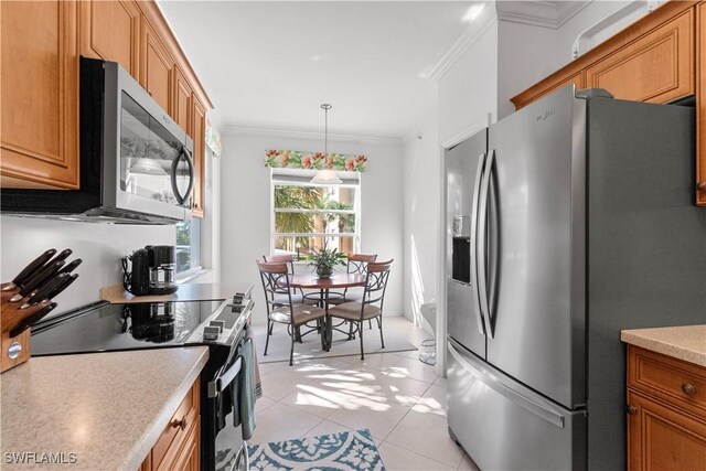 kitchen with stainless steel appliances, ornamental molding, brown cabinetry, and light countertops