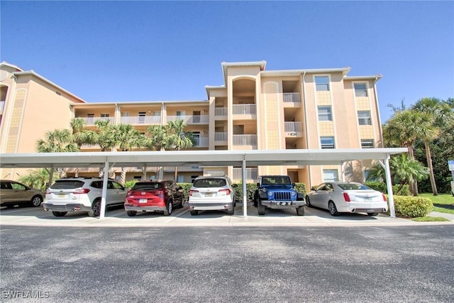 view of building exterior featuring covered parking