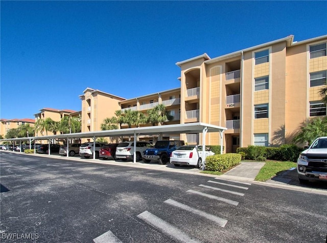 view of property featuring covered parking