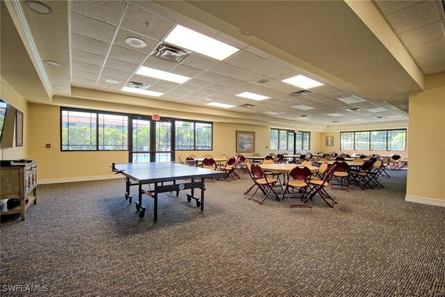 playroom with dark colored carpet, visible vents, and a healthy amount of sunlight