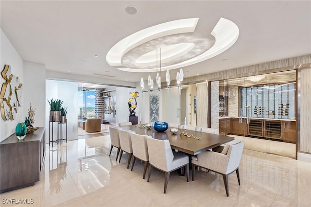 dining space with a raised ceiling