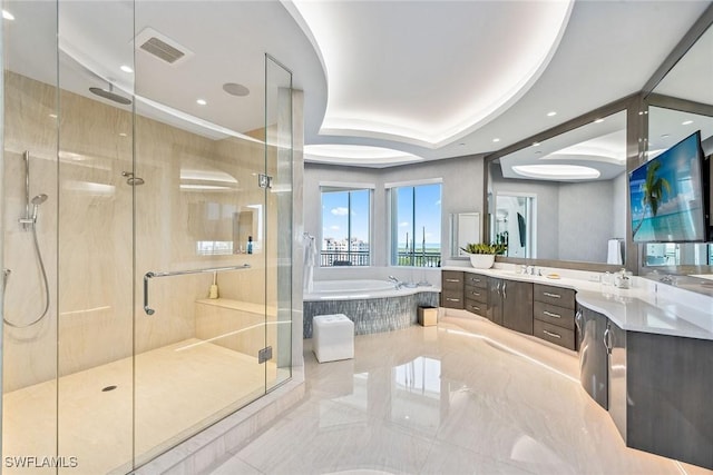 full bathroom featuring a tray ceiling, a garden tub, visible vents, a stall shower, and vanity