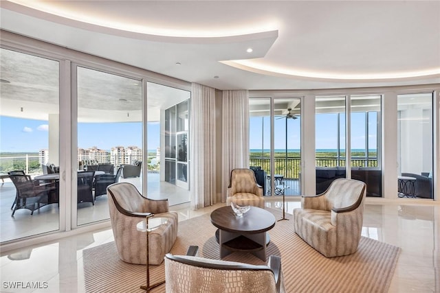 interior space featuring plenty of natural light, expansive windows, and a tray ceiling