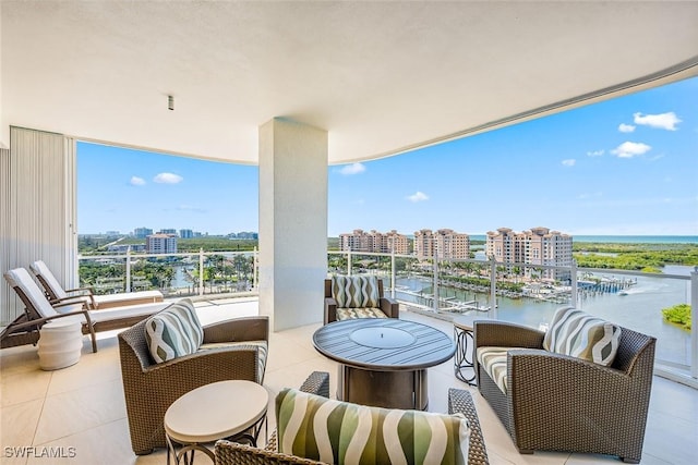 balcony featuring a view of city and a water view