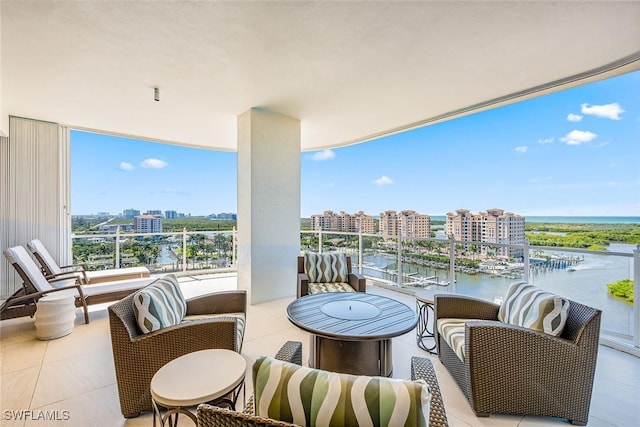 balcony featuring a water view and a city view