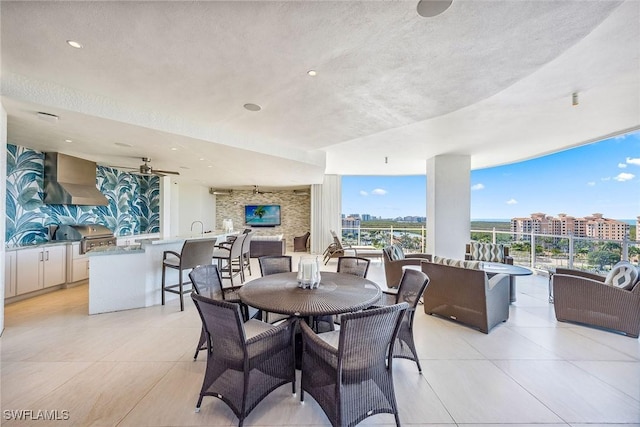 dining area featuring light tile patterned floors, a ceiling fan, a textured ceiling, floor to ceiling windows, and recessed lighting