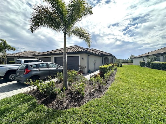 view of home's exterior with a garage, driveway, a lawn, a tile roof, and stucco siding