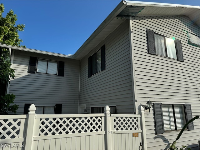 view of property exterior featuring a fenced front yard and a gate